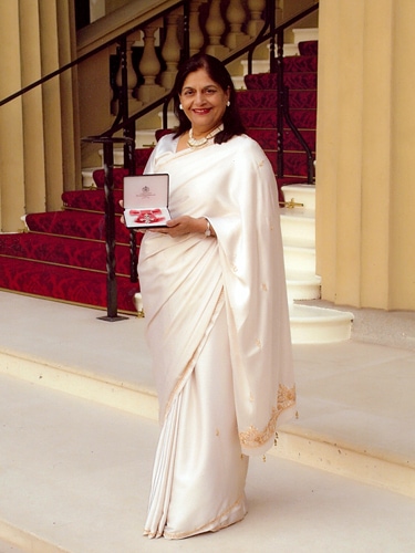 Manjula proudly receiving her MBE in November 2009 for contributions for the local community